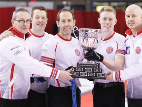 From left to right;, John Dunn (coach) Ben Hebert (lead) Brent Laing (second) Marc Kennedy (third) and Kevin Koe (skip) hold the Boston Pizza trophy after winning the Alberta men`s title in Wainwright on Sunday, February 8, 2015. ZAK MCLACHLAN Wainwright Star News Sun Media
