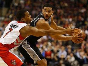 Raptors’ Kyle Lowry (left) reaches in past the Spurs’ Cory Joseph last night. Joseph, who isn’t receiving a lot of minutes with Tony Parker now healthy, had four points in the game. (Jack Boland/Toronto Sun)