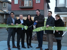 Cutting the ribbon at the Henley Heights grand opening on Jan. 29 were (L-R) Dee Tran from Bedrock Homes, Dave Armstrong from Connect Homes, Maria Kennedy from Homes by Avi, Sam Everitt from Walton, Wade Grabeldinger from Crimson Cove Homes and Kendra Milne from Walton.