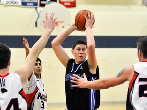 David DIxon of the MDHS senior boys basketball team is surrounded by opponents during recent Huron-Perth action. ANDY BADER/MITCHELL ADVOCATE