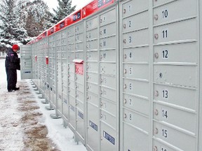 Don Pfeifer of Canada Post fills the new community mailboxes located in Monkton last week. KRISTINE JEAN/MITCHELL ADVOCATE