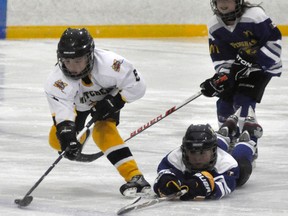 Xavier Lorentz breaks away from two Wingham defenders during OMHA Group 4 AE action. ANDY BADER/MITCHELL ADVOCATE