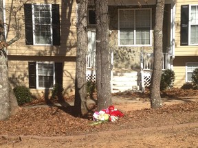 A memorial with flowers and a stuffed teddy bear is seen outside the home where seven people were shot near Douglasville, Georgia February 8, 2015.  The attack on Saturday left five people dead and occurred about 20 miles (32 km) west of Atlanta. Two children and three adults were killed, including the shooter, and two more children were critically injured. REUTERS/Rich McKay