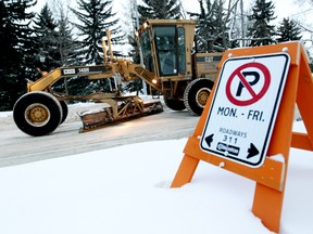 Grader crews clear 95 Avenue near Holyrood Road, in Edmonton Alta., on Jan. 6, 2013. David Bloom/Edmonton Sun
