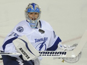 Tampa Bay Lightning goalie Evgeni Nabokov makes a save on a shot from the Calgary Flames on October 21, 2014. (Stuart Dryden/Calgary Sun/QMI Agency)