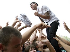 Anti-Flag bassist Chris Barker jumps in to the crowd during the Vans Warped Tour at Northlands on August 5, 2010 in Edmonton, Alberta.  JORDAN VERLAGE/EDMONTON SUN/QMI AGENCY