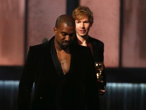 Beck watches Kanye West, who pretended to take the stage after Beck won album of the year for "Morning Phase," at the 57th annual Grammy Awards in Los Angeles, California February 8, 2015.  REUTERS/Lucy Nicholson