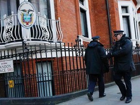 Police officers walk past the Ecuador embassy following a shift change in London February 6, 2015. REUTERS/Suzanne Plunkett