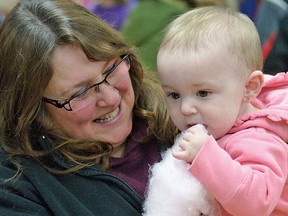 Elena Robillard-Mardue and her grandmother Tammy Westra sample some cotton candy during the 2014 Family Day carnival at the Tillsonburg Community Centre. In addition to events at Annandale National Historic Site (scavenger hunt, family history lessons and guided tours), a wide variety of Family Day events will be held once again at the Community Centre on Monday, Feb. 16, 2015, including free swims, free skates, free carnival, free entertainment, a visit from a Canadian Olympian, and affordable family breakfast and lunch. CHRIS ABBOTT/TILLSONBURG NEWS