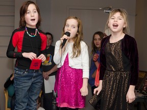 Jennifer Blackburn (9), Abby Tremblay (9), and Alexis Tremblay (9) perform during Friday night's  Karaoke Night at the Cochrane Public Library. The trio won Best Group.