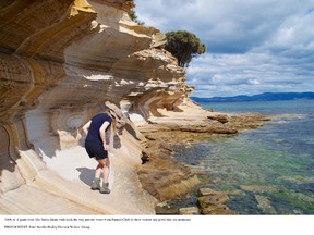 A guide from The Maria Island Walk leads the way past the water-worn Painted Cliffs to show visitors tiny sea anemones. PETER NEVILLE-HADLEY/HORIZON WRITERS' GROUP