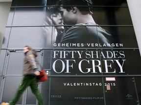 A pedestrian walks past an advertising placard for the movie 'Fifty Shades of Grey'. (REUTERS/Fabrizio Bensch)