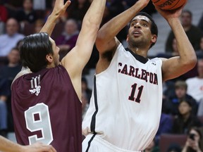 Thomas Scrobb of the Carleton Ravens shoots over Matt Plunkett of  the Ottawa Gee-Gees during the MBNA Capital Hoops Classic at the Canadian Tire Centre in Ottawa Friday Feb. 6, 2015. Tony Caldwell/Ottawa Sun/QMI Agency