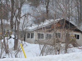 Smoke pours from a house on Escott-Rockport Road as Leeds and Thousand Islands firefighters battle a fire Tuesday Feb. 10, 2015 near Rockport Ontario. Nick Gardiner/Brockville Recorder and Times/QMI Agency