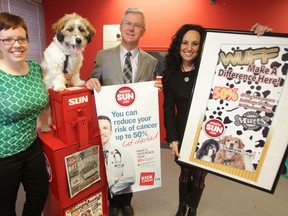 Left to right: Colleen Holloway, of Manitoba Mutts Dog Rescue, Charlie a MMDR alumni pooch; Bob Jones, of CancerCare Manitoba, and Sun Publisher Daria Zmiyiwsky gather to recognize Sun donations to the respective charities.