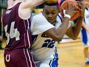 Beal's Franck Ngakoutou battles with Banting's Kyle Morris during their game at Beal Secondary  in London, Ont. on Tuesday February 10, 2015.  (MIKE HENSEN, The London Free Press)