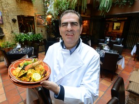 Felipe Gomes displays a plate of seafood paella at the Aroma Restaurant. While local ingredients are important to the veteran restaurateur, Gomes says his menu draws inspiration from his Portuguese heritage and the simple, satisfying dishes of his childhood in Lisbon. (MORRIS LAMONT, The London Free Press)