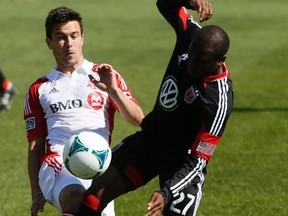 Sainey Niassi, right, battles Toronto FC's Andrews Wiedeman for the ball during a gaqme in 2013. (Stan Behal file, QMI Agency)