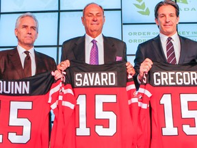 From left: Hockey Canada boss Tom Renney, businessman Jim Treliving, and Maple Leafs boss Brendan Shanahan hold sweaters with the names of the three men given the Order of Hockey in Canada yesterday at the Air Canada Centre. (Dave Thomas/Toronto)