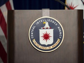 The lectern stands empty as reporters await the arrival of Director of Central Intelligence Agency John Brennan for a press conference at CIA headquarters in McLean, Virginia, December 11, 2014.  AFP PHOTO/JIM WATSON
