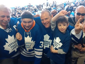 (Left to right) Lou and Laura Maieron, Richard and Nathan Skleryk, John and Aristotle Kakarelis enjoy a night at the ACC, despite another Leafs loss. (JOE WARMINGTON/Toronto Sun)