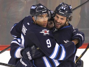 Winnipeg Jets left winger Evander Kane (left) is hugged by defenceman Zach Bogosian after scoring in this file photo. (BRIAN DONOGH/WINNIPEG SUN FILE PHOTO)