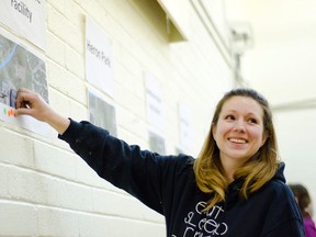 Jennifer Draper votes for her ideal site for a Pincher Creek splash park during a meeting held in the town hall gym on Wednesday, Feb. 4, 2015. John Stoesser photos/QMI Agency.
