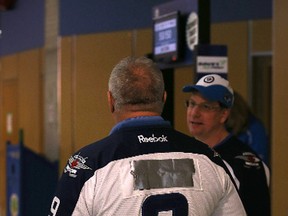 A Winnipeg Jets fan covers Evander Kane's name on the back of his jersey last Friday night. River City Sports deeply discounted Kane and Zach Bogosian's jerseys on Wednesday after the pair were traded to Buffalo. (Kevin King/Winnipeg Sun file photo)