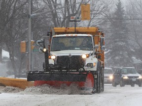 A snowplow cleans the streets in Ottawa, Ont. Friday Feb 8, 2013. Between 5-10 centimeters of snow fell overnight in Ottawa. Tony Caldwell/Ottawa Sun/QMI Agency