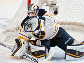 Buffalo Sabres goalie Jhonas Enroth makes a stop in the third period of a game against the Montreal Canadiens at the Bell Centre on February 3, 2015. (BEN PELOSSE/JOURNAL DE MONTRÉAL/QMI AGENCY)