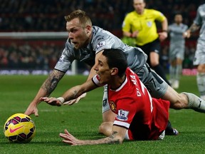 Burnley's Scott Arfield (top) fouls Manchester United's Angel Di Maria to concede a penalty during their English Premier League match at Old Trafford in Manchester February 11, 2015. (REUTERS/Phil Noble)