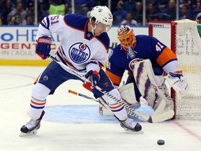 Anton Lander controls the puck in front of Islanders goaltender Jaroslav Halak Tuesday in Uniondale, N.Y. (USA TODAY SPORTS)