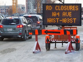 A City of Edmonton sign warns motorist of a road closure, in Edmonton Alta., on Monday Jan. 4, 2015. Starting Tuesday January 6, 2015, 104 Avenue between 101 and 103 Street will be closed to overnight traffic weekdays, from 7pm to 6am, for construction work on the Winter Garden pedway for the new downtown arena. The overnight road closure will continue for approximately six months. The road will be open for peak hour traffic. David Bloom/Edmonton Sun