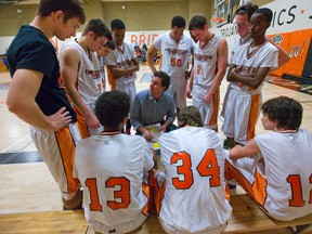 Trojan coach Aaron Casella talks to his team during a time out in a TVRA Central senior boys basketball game on Wednesday. The Trojans had a great season, going 11-1 before heading into the playoffs next week where they will meet Laurier, the only team to beat them in the regular season. (Mike Hensen, The London Free Press)
