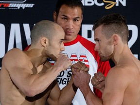 Marlon Moraes and Josh Hill square off  at the Sutton Place Hotel on Wednesday during the weigh-in for their World Series of Fighting 18 bantamweight world title fight, scheduled for Thursday at the Edmonton Expo Centre. World Series of Fighting president Ray Sefo is pictured centre. (David Bloom, Edmonton Sun)