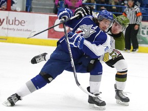Sudbury Wolves Danny Desrochers and North Bay Battalion Brett Mckenzie fight for position during OHL action between the Sudbury Wolves and North Bay Battalion from the Sudbury Community Arena on Wednesday February 11/2015