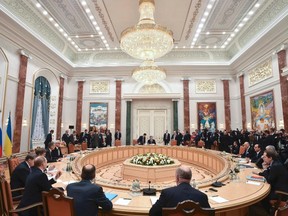 Members of delegations from Russia, Ukraine, Germany and France take part in peace talks on resolving the Ukrainian crisis in Minsk, February 11, 2015.   REUTERS/Kirill Kudryavtsev/Pool