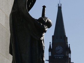 The Canadian flag flies from the Peace Tower on Parliament hill, in view from the statue entitled Justice in front of the Supreme Court of Canada. (Reuters)