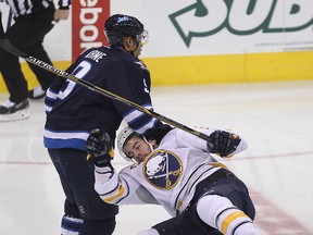 Evander Kane  (left) dumps right winger Drew Stafford during NHL hockey in Winnipeg, Man. Tuesday, December 16, 2014. The pair have now switched teams.