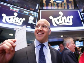 King CEO Riccardo Zacconi holds up a trade ticket during the IPO of Mobile game maker King Digital Entertainment Plc on the floor of the New York Stock Exchange in this file photo taken March 26, 2014. REUTERS/BRENDAN MCDERMID