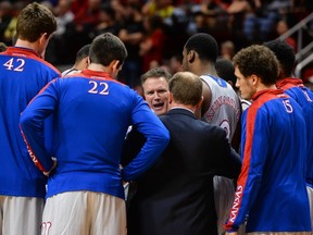 Head coach Bill Self of the Kansas Jayhawks talks with his team during a timeout against the Texas Tech Red Raiders on February 10, 2015 at United Supermarkets Arena in Lubbock, Texas. (John Weast/Getty Images/AFP)