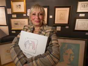 Curator Lynne Clifford stands among the late John Lennon's artwork on display for a month starting Feb. 14 at the Liss Gallery in Toronto Thursday, February 12, 2015. (Stan Behal/Toronto Sun)