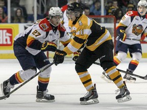Kingston Frontenacs rookie Zack Dorval battles for the puck against the Erie Otters’ Jake Marchment during a game at the Rogers K-Rock Centre on Jan. 30. (Julia McKay/The Whig-Standard)