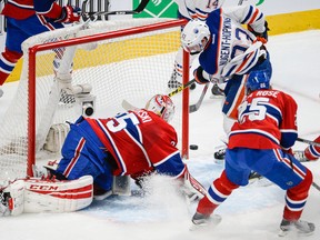 Ryan Nugent-Hopkins scores the first of his two goals on Canadiens goaltender Dustin Tokarsky during the second period Thursday in Montreal. (Martin Chevalier, QMI Agency)