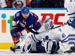 Maple Leafs goalie Jonathan Bernier makes the save as forward John Tavares looks for the rebound during the third period in Uniondale, N.Y.  Bernier faced 41 shots in the 3-2 loss. (AFP)