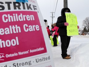 Registered nurse and care coordinator Melissa Cousins, right, pickets outside the South East Community Care Access Centre headquarters at the Bay View Mall in Belleville, Ont. Wednesday, Feb. 11, 2015. - File/Luke Hendry/The Intelligencer/QMI Agency