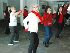 Phyl McCrum (centre) makes the song her own during Oxford's One Billion Rising dance and demonstration on Friday. (Megan Stacey/Sentinel-Review)​