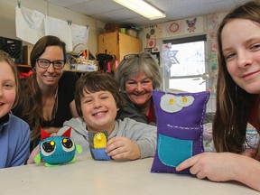 Brianna Lambert, left, Kelly Graham, Ben Emslie, Elinor Rush and Hailey Hannah show off their finished e-textile projects on Tuesday February 10, 2015. Through designing and sewing their individual projects, the students learn about stress management, community building and methods to use when developing new skills. Julia McKay/The Kingston Whig-Standard/QMI Agency