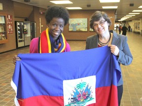 Haitian-born Darline Lloyd, left, holding the Haitian flag, will be returning to her country as a new teacher next month with Linda Adams Leroux, a current teacher at Welborne Public School, to provide new programming techniques to Haitian educators...FRI., FEB. 13, 2015...KINGSTON, ONT. MICHAEL LEA THE WHIG STANDARD QMMI AGENCY