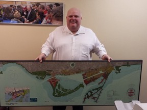 Rob Ford with a poster of the Port Lands that is currently for sale on eBay. (eBay photo)